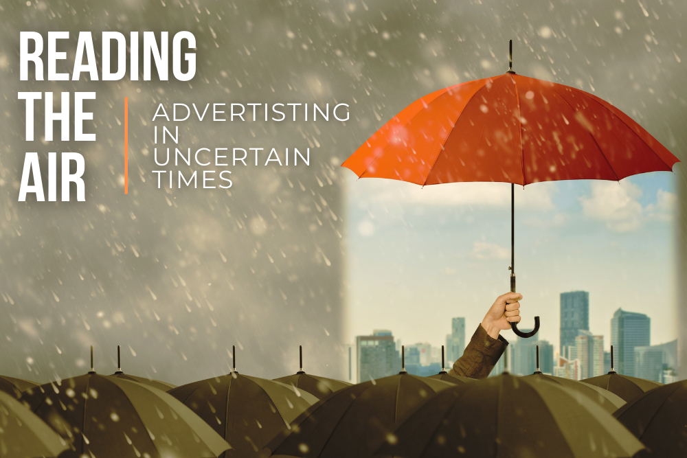 A cover of rained-on umbrellas, one rises above & provides sunshine. Text: Reading the Air: Advertising in Uncertain Times.