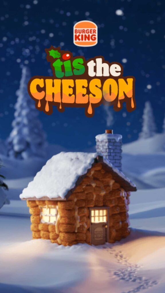 "Burger King 'Tis the Cheeson' holiday ad featuring a cozy log cabin in a snowy landscape with the campaign slogan above.